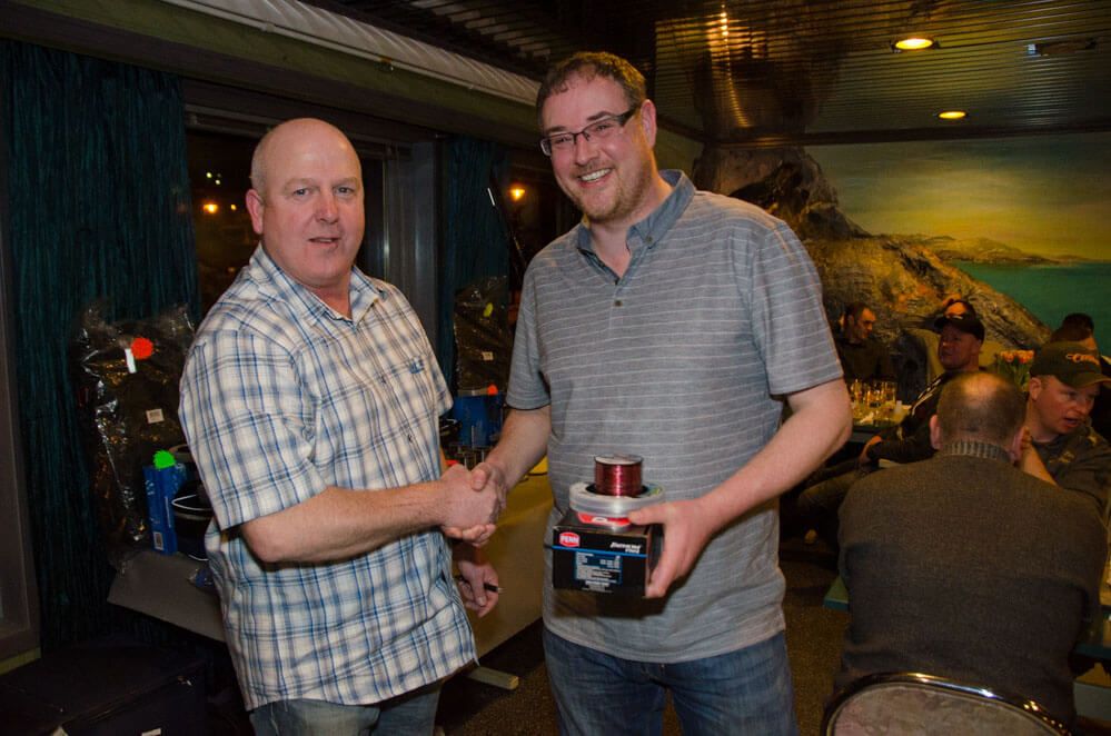 Barrie Stowells receives his prize for the best round specimen